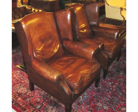 WING ARMCHAIRS, a pair, George III design with faded tobacco brown deep button leather and upholstered backs. (2)