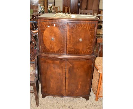 A mahogany veneered bow front four door drinks cabinet