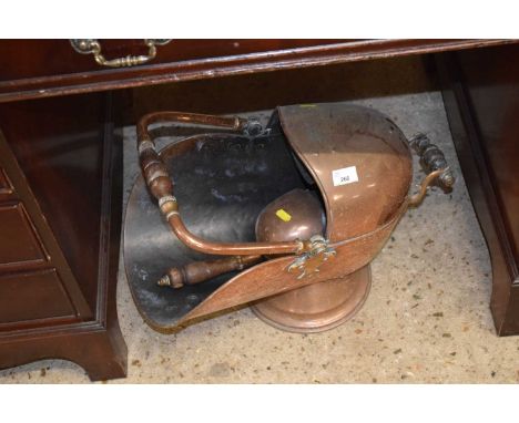 A copper coal chute with shovel