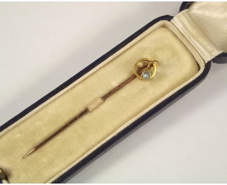 STICK PIN.
A 15ct. gold, pearl & aquamarine stick pin, cased.