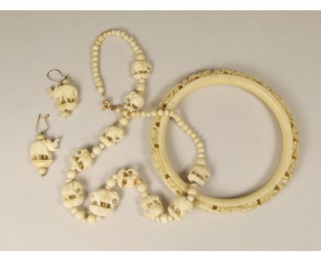 IVORY ETC.
A 1920's Chinese carved ivory slave bangle, a bone necklace & earrings.