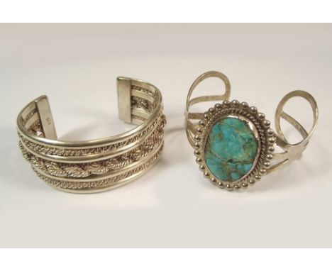 BANGLES.
A North American style, hallmarked silver bangle & a heavy silver cuff bangle.
