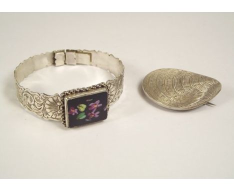 BANGLE & BROOCH.
A 19th century engraved silver bangle with enamelled porcelain front & an unusual shell brooch, with hair co