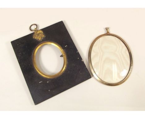 FRAMES.
A Georgian lacquered & gilt metal frame & a silver frame for a portrait miniature.