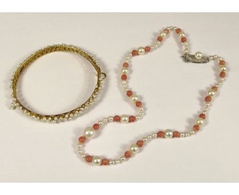 CORAL & PEARL.
A cultured pearl & coral necklace & a Middle Eastern yellow metal & river pearl bangle.