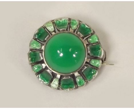 ELLA NAPER.
A rare brooch designed & made by Ella Naper of Lamorna. The flowerhead design, enamelled in green & with a green 