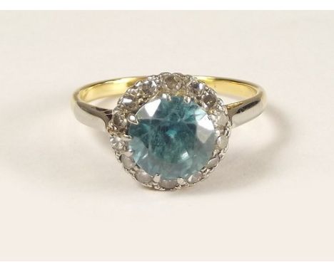 DRESS RING.
A gold, blue topaz & diamond cluster ring. Size K/L.