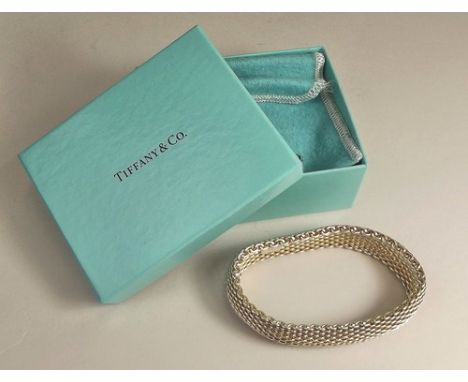 TIFFANY & CO.
A Tiffany & Co, 'Somerset' design, silver mesh bangle with original pouch & box.
Stamped. Approx. 55g.