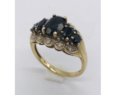 A 9ct gold diamond and sapphire cluster ring