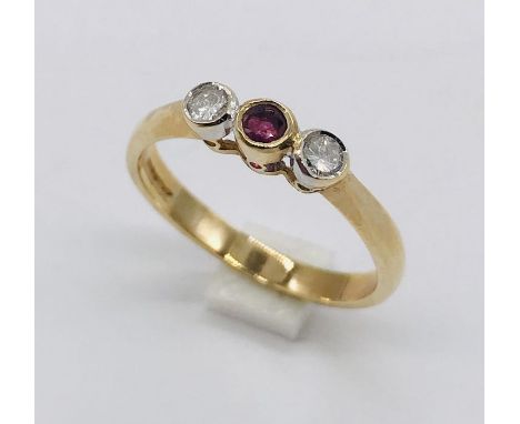 A 9ct gold three stone ring set with diamonds and ruby