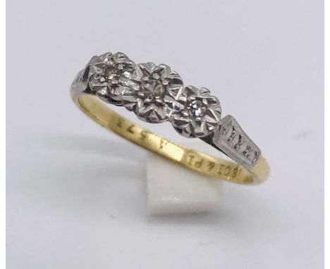 An 18ct gold and platinum illusion set diamond three stone ring. Total weight 2.2g.