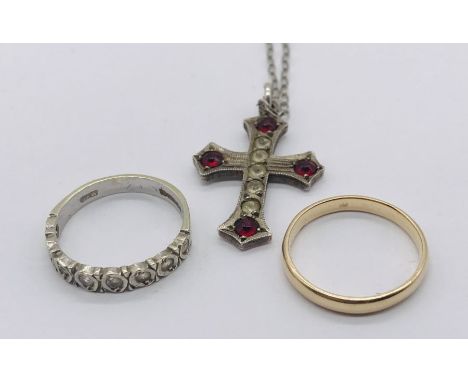 A 9ct gold wedding band along with a 9ct eternity ring and a silver gem set cross on chain (total gold weight 3.5g)
