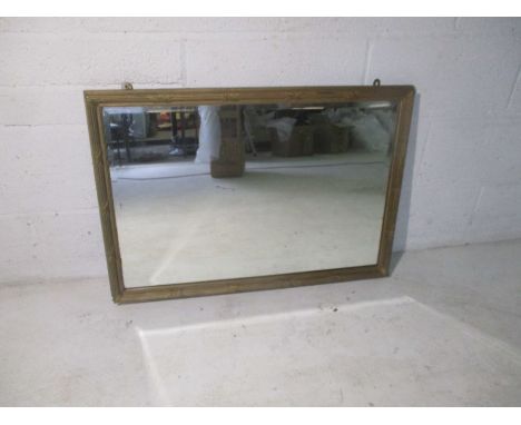A gilt framed bevel edged mirror.