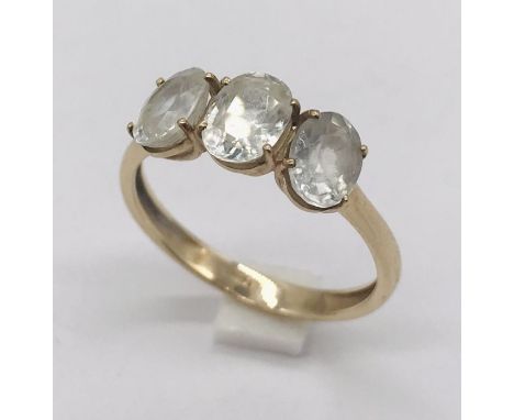 A 9ct gold three stone ring set with white topaz