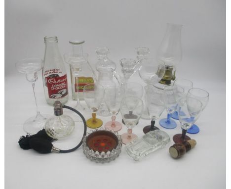 A collection of glass items including an oil lamp, Cadbury's bottle, perfume bottle etc.