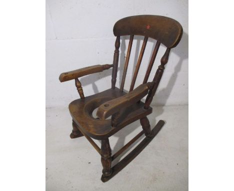 A child's Windsor stick back rocking chair commode