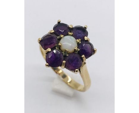 A 9ct gold cluster ring set with garnets and opal