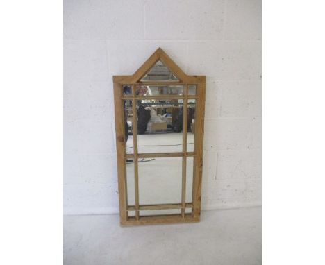A wooden framed gothic mirror