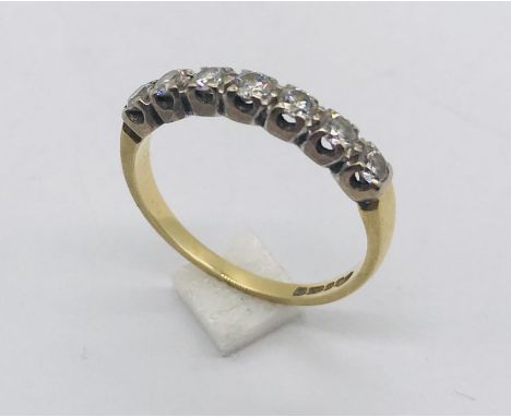 An 18ct gold diamond half eternity ring. Total weight 2.3g.