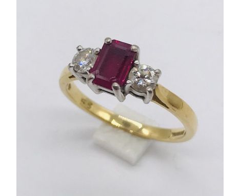 A diamond and ruby three stone ring set in 18ct gold