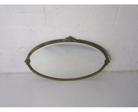 A brass framed oval bevel edged mirror.