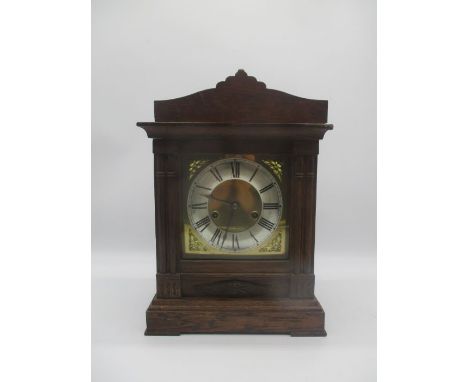 A 20th century oak cased mantle clock. with brass face.