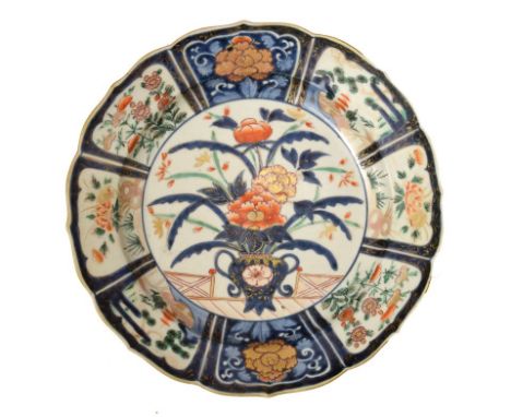 19th Century Japanese Imari porcelain shallow dish, of wavy outline decorated in underglaze blue, iron-red, green and gilt wi