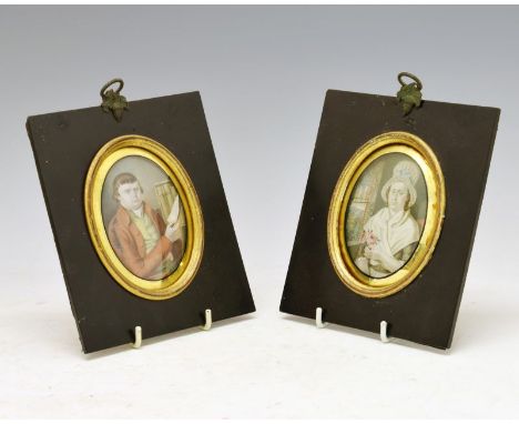 Pair of late 18th/early 19th Century portrait miniatures, a lady in a cap holding pink roses, and a gentleman in red jacket h