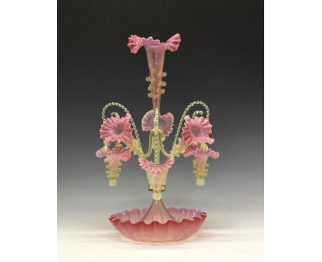 Victorian 'Vaseline' glass epergne, the central frilled pink trumpet vase with lemon glass scallop decoration and stem, frame