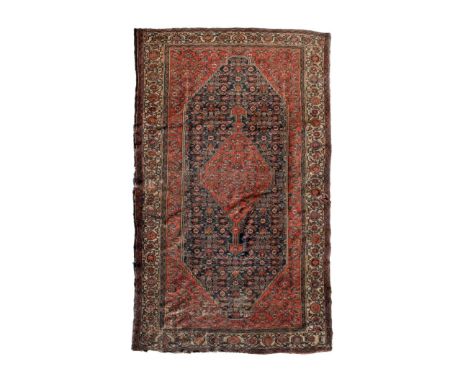 Early to mid 20th Century Middle Eastern (Persian) rug or carpet, the tomato-red field decorated with boteh and flowerheads f