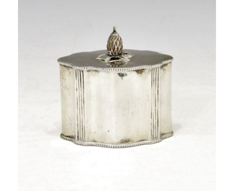 Edward VII silver tea caddy of fluted oval form, the hinged lid with pineapple shaped finial, London 1909, sponsors mark of C
