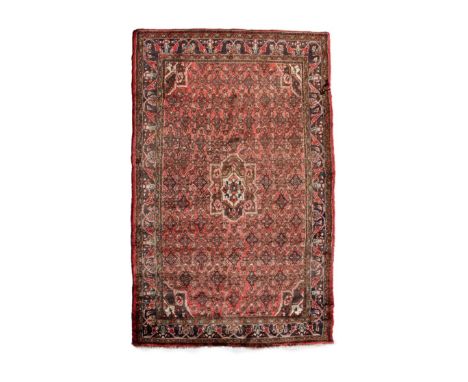 Middle Eastern Persian (Hamadan) wool rug or carpet, the brick-red field with central lobed medallion within densely-packed l