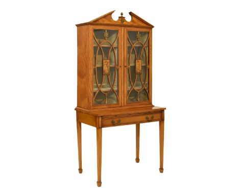 Early 20th Century inlaid satinwood cabinet on stand, the upper stage with architectural 'broken' pediment over a pair of gla