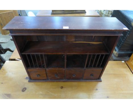 A mahogany wall mounted shelf