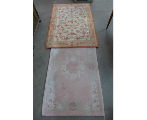A Chinese pink ground rug and a Laura Ashley tapestry wall hanging
