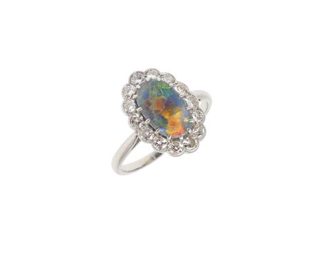 the oval-shaped solid black opal is set within a surround of old-cut diamonds, in platinum, 2.8 grams. Size H 1/2. *CR Some a