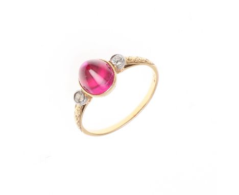 the domed-shaped synthetic ruby is set with a circular old-cut diamond to each shoulder in yellow gold, 2.0 grams. Size K 1/2