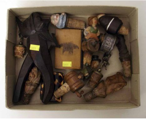 Collection of black forest carved bottle stoppers, a silver napkin ring, nut cracker and treen etc. Condition report: see ter