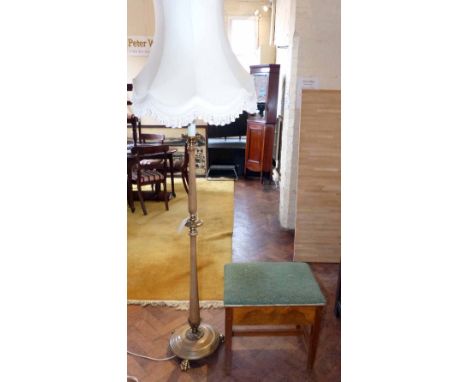 Standard lamp having turned column complete with brass fittings on paw feet and music stool with upholstered lid. Condition r