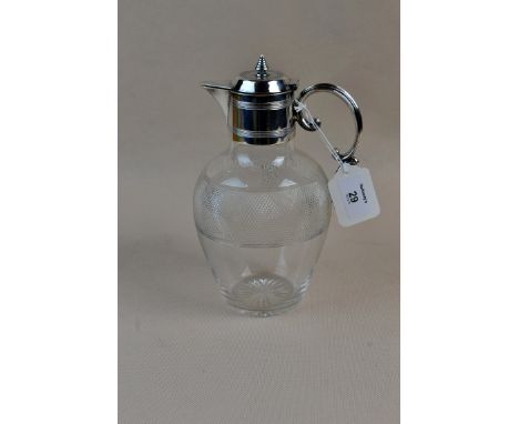 A hob nail cut crystal claret jug with plated mounts, bee hive finial and scrolled handle, 22 cm