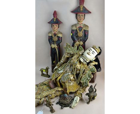 A Balinese carved and painted puppet, together with a pair of primitive carved wooden figures of 19th century generals and ot