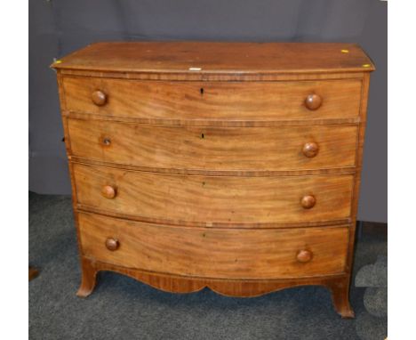 A Regency mahogany chest of bow front form, having four graduated long drawers with knop handles on bracket feet