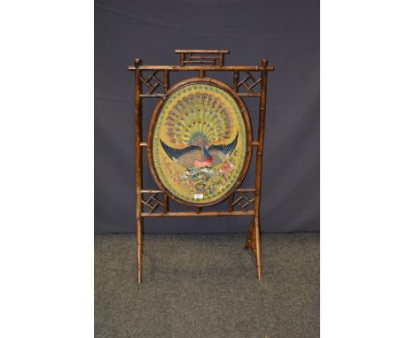 An Aesthetic Movemnt/Japanoise bamboo firescreen, set with woven silk panels of peacocks and other exotic birds, 105 x 60 cm,