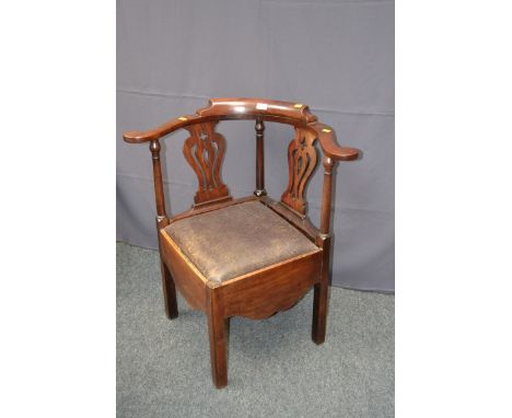 A George II/III mahogany corner commode armchair, with bow back and sloper and pierced splats