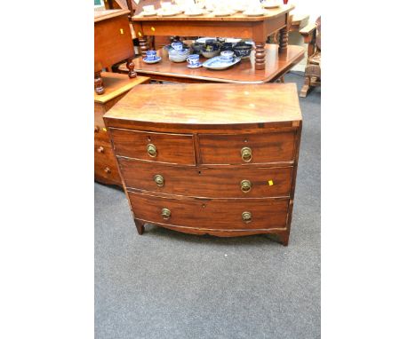 A George III mahogany bow fronted chest, of two short over two long drawers