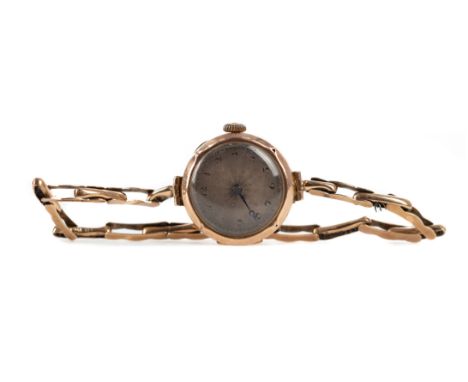 LADY'S ART DECO NINE CARAT GOLD CASED MANUAL WIND WRIST WATCH, the round engine turned dial with Arabic hour markers, dot out