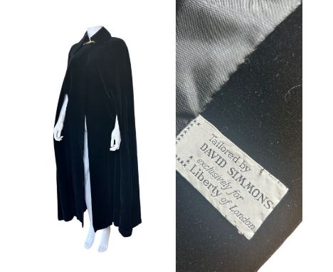 A C1970s velvet cloak in black velvet with decorative double button finish to the neck along with 7 pairs of vintage gloves (