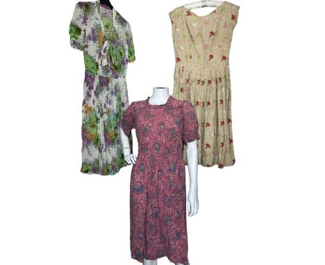 A late 30s/ early 40s day dress in mauve with shirred detail, a 50s novelty print day dress in cotton and a floral crepe geor