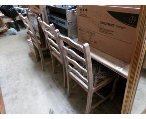 A large dining table and 6 ladder back chairs