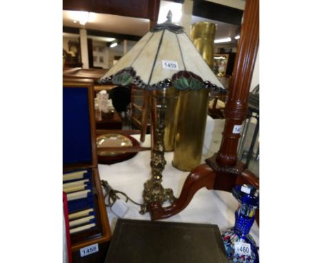 A Tiffany style table lamp with brass plated column and leaded glass shade
